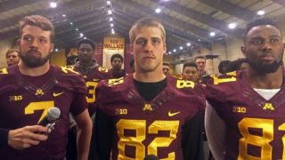 From left to right quarterback Mitch Leidner, wide receiver Drew Wolitarsky and tight end Duke Anyanwu stand with the rest of their team. Wolitarsky read a statement saying the players would boycott all football activities. Peter Cox | MPR News