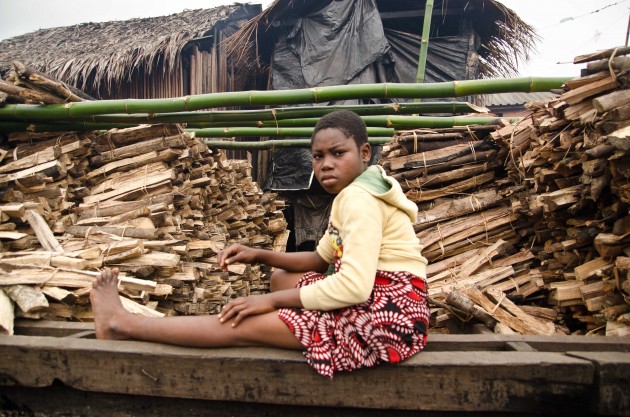 Piles of wood are needed to smoke the fish that are caught by Makoko's fishermen. (MPR Photo/Nate Minor)